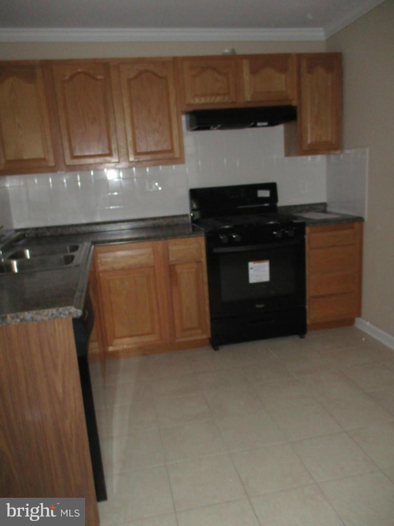 8200 Northview Road Baltimore, MD 21222 - Photo 4 of 14 a kitchen with stainless steel appliances granite countertop a stove a refrigerator and a sink