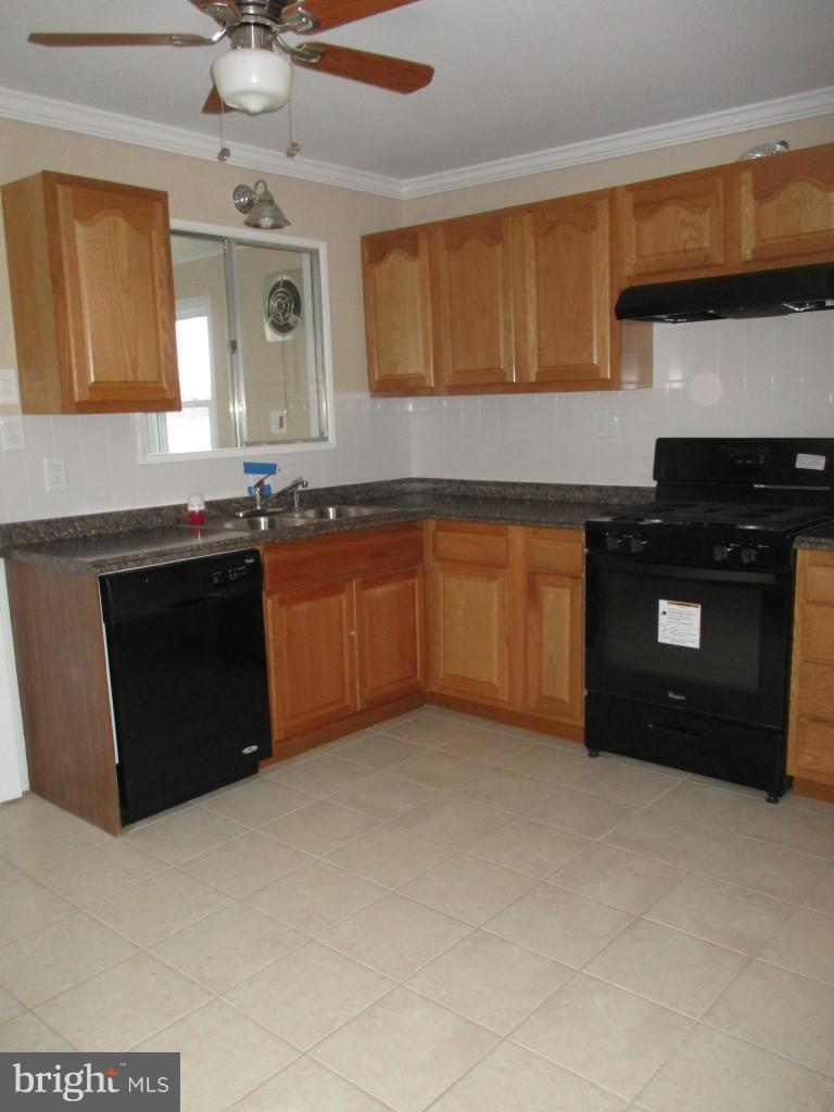 8200 Northview Road Baltimore, MD 21222 - Photo 5 of 14 a kitchen with stainless steel appliances granite countertop a stove a sink and a microwave