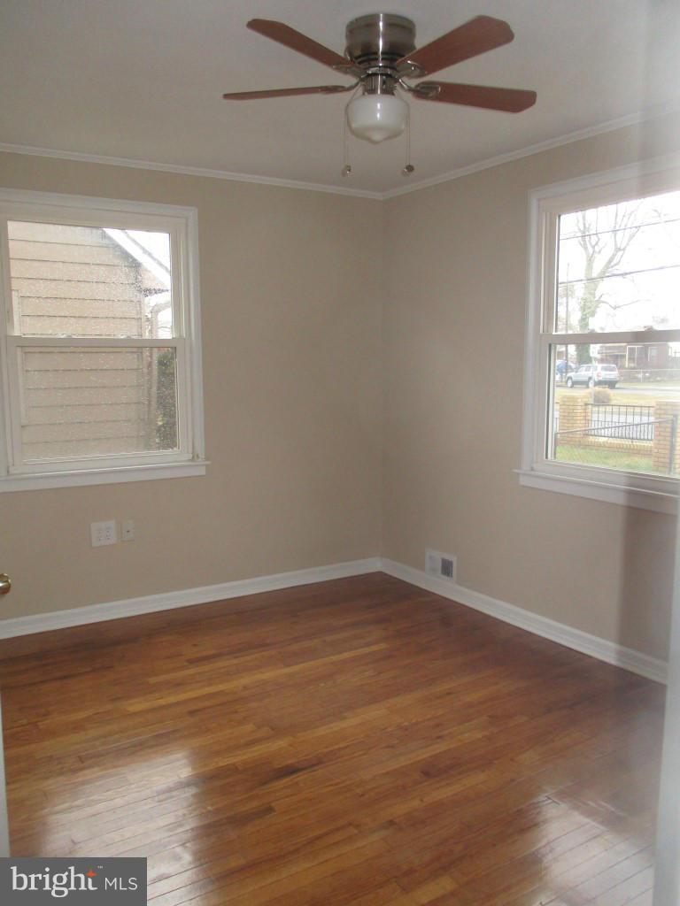 8200 Northview Road Baltimore, MD 21222 - Photo 6 of 14 a view of an empty room with wooden floor and a window