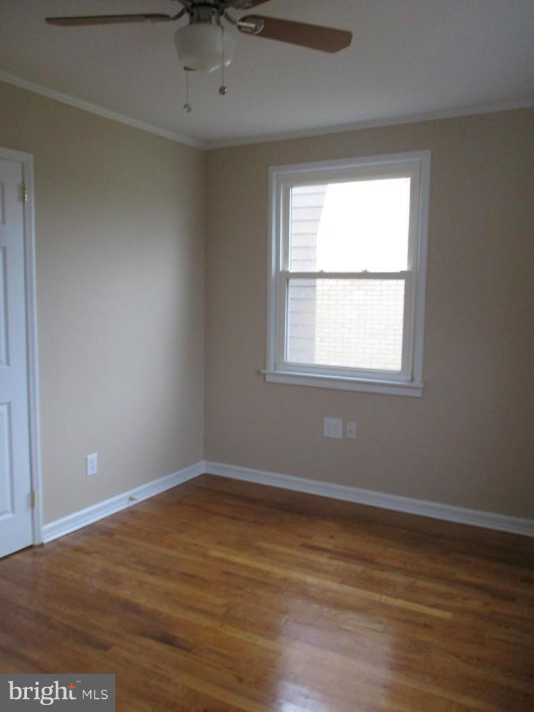 8200 Northview Road Baltimore, MD 21222 - Photo 7 of 14 an empty room with wooden floor and windows