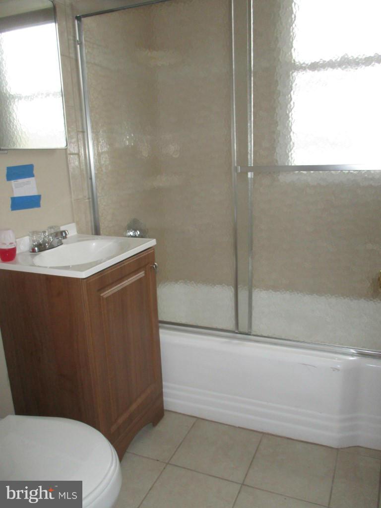 8200 Northview Road Baltimore, MD 21222 - Photo 8 of 14 a bathroom with a sink a toilet and shower