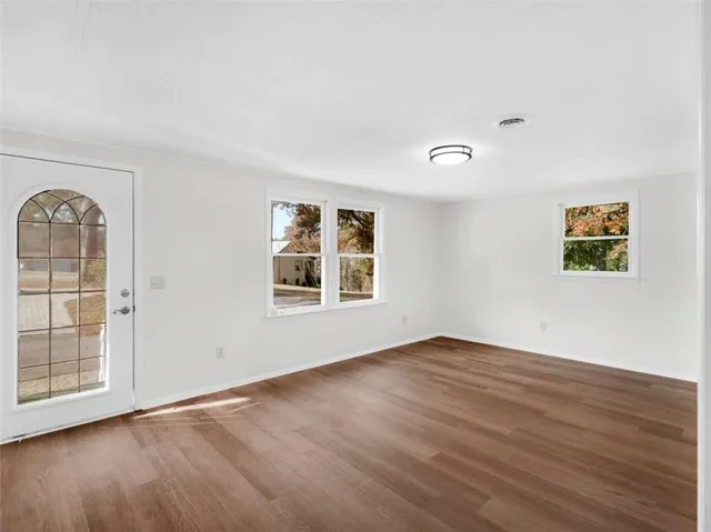 a view of a livingroom with a ceiling fan & window