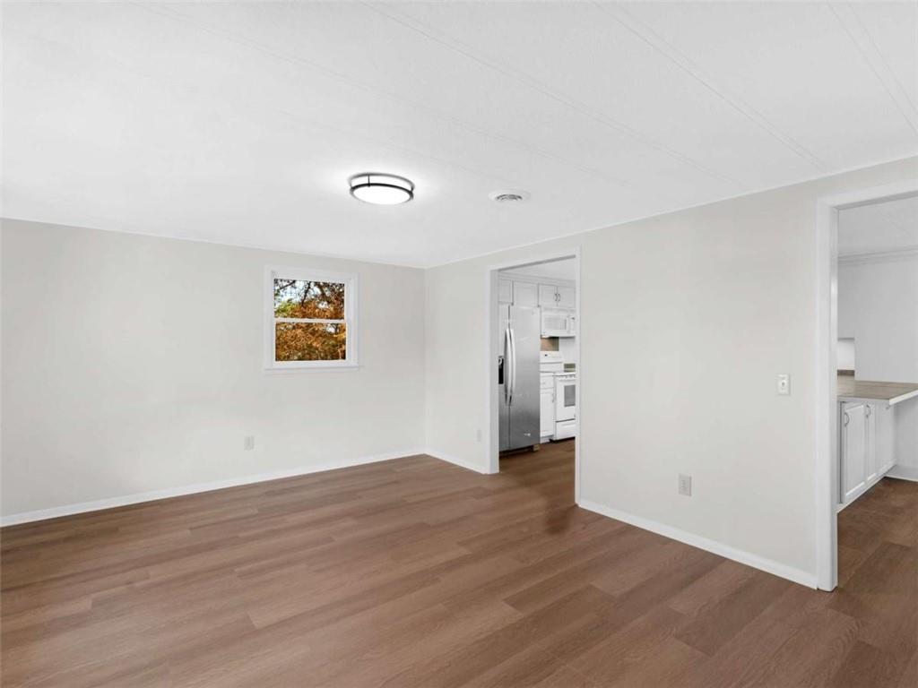 296 Reeves Road Jackson, GA 30233 - Photo 21 of 78 a view of an empty room with wooden floor and a window