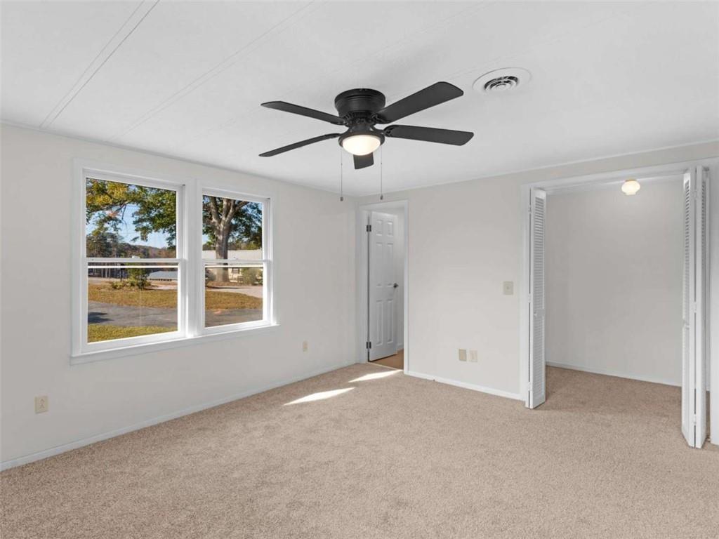 296 Reeves Road Jackson, GA 30233 - Photo 33 of 78 a view of a livingroom with a ceiling fan & window