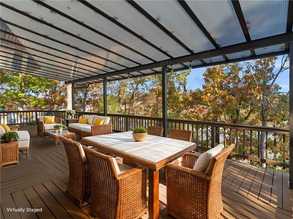 296 Reeves Road Jackson, GA 30233 - Photo 52 of 78 a view of a balcony with chairs and wooden floor