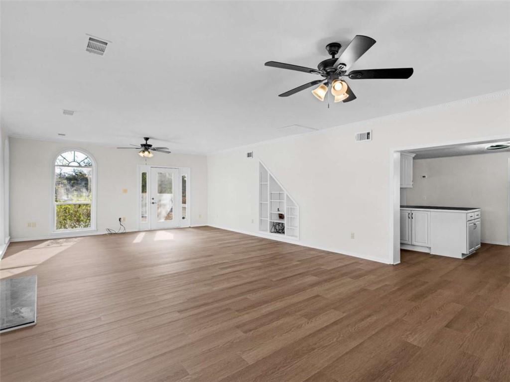 296 Reeves Road Jackson, GA 30233 - Photo 7 of 78 a view of a livingroom with a ceiling fan window and wooden floor