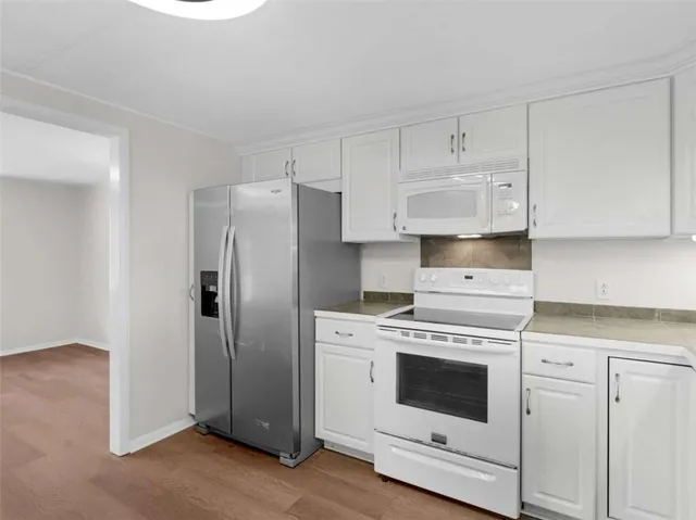 a kitchen with granite countertop cabinets stainless steel appliances and a sink