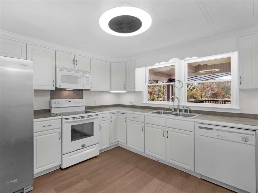 296 Reeves Road Jackson, GA 30233 - Photo 10 of 78 a kitchen with granite countertop cabinets stainless steel appliances and a sink