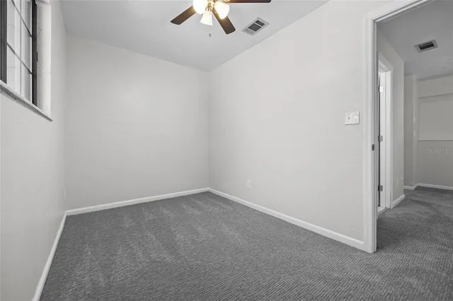 an empty room with a empty space and windows