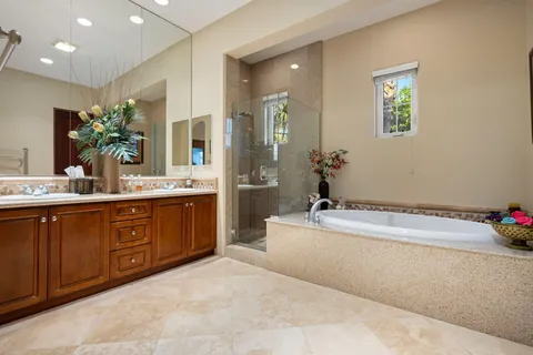 a bathroom with a tub sink and mirror