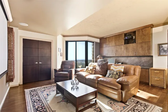 a bathroom with a granite countertop sink a toilet a mirror and shower