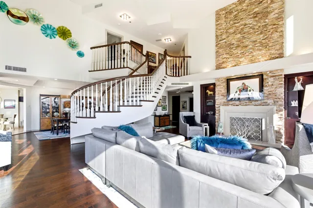 a living room with furniture and floor to ceiling window