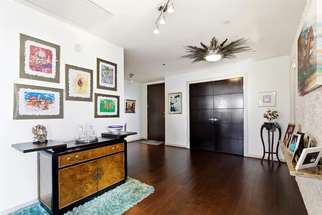 a living room with furniture and a table with wooden floor