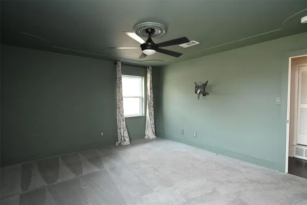 a view of a livingroom with a chandelier fan