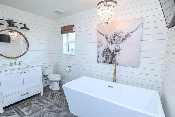 a bathroom with a sink a toilet and bathtub