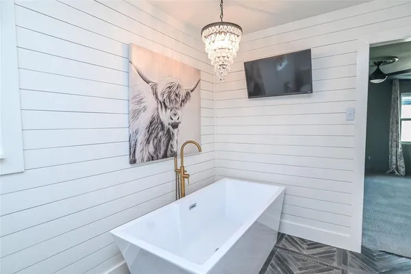 a bathroom with a sink a mirror and bathtub