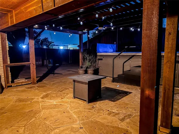 a view of a porch with furniture and a garage
