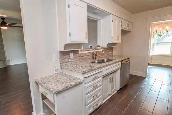 a kitchen with stainless steel appliances granite countertop a sink stove and cabinets