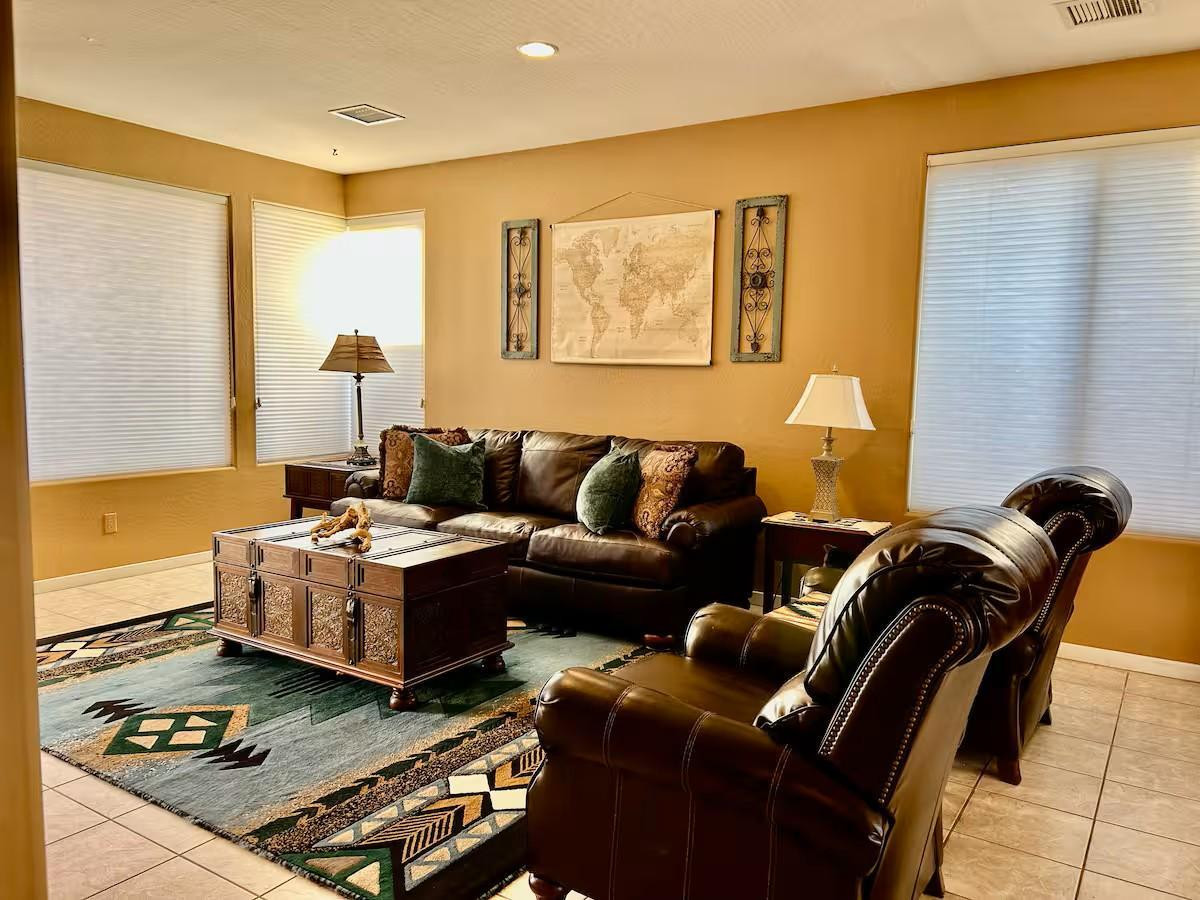a living room with hard wood flooring and furniture