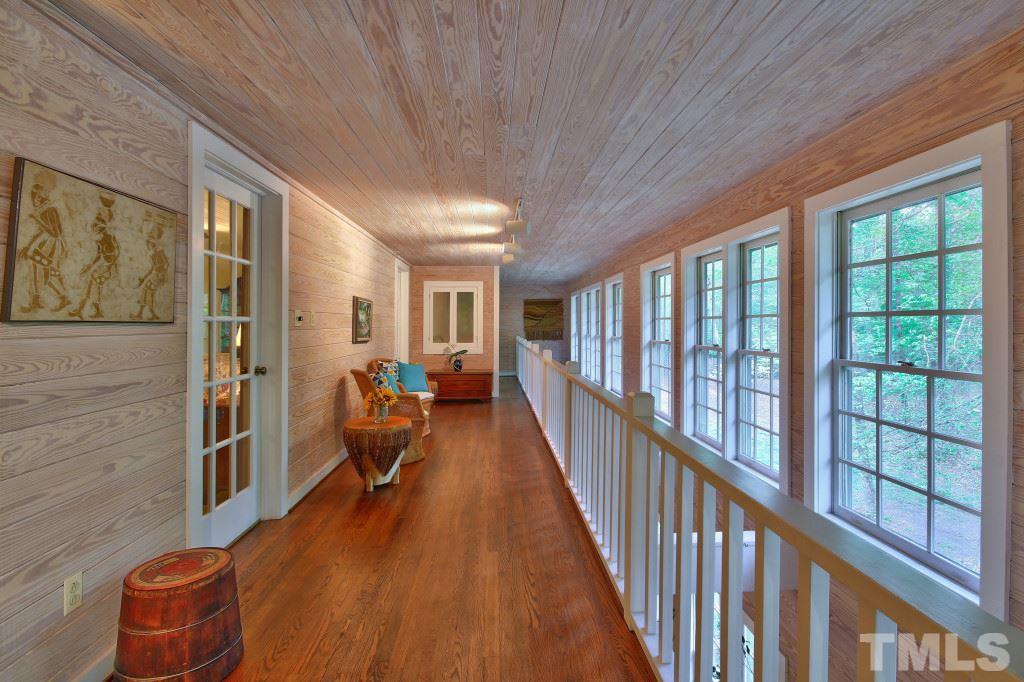 6257 Moore Road Red Oak, NC 27856 - Photo 12 of 25 a view of a hallway with the couches and dining table chairs