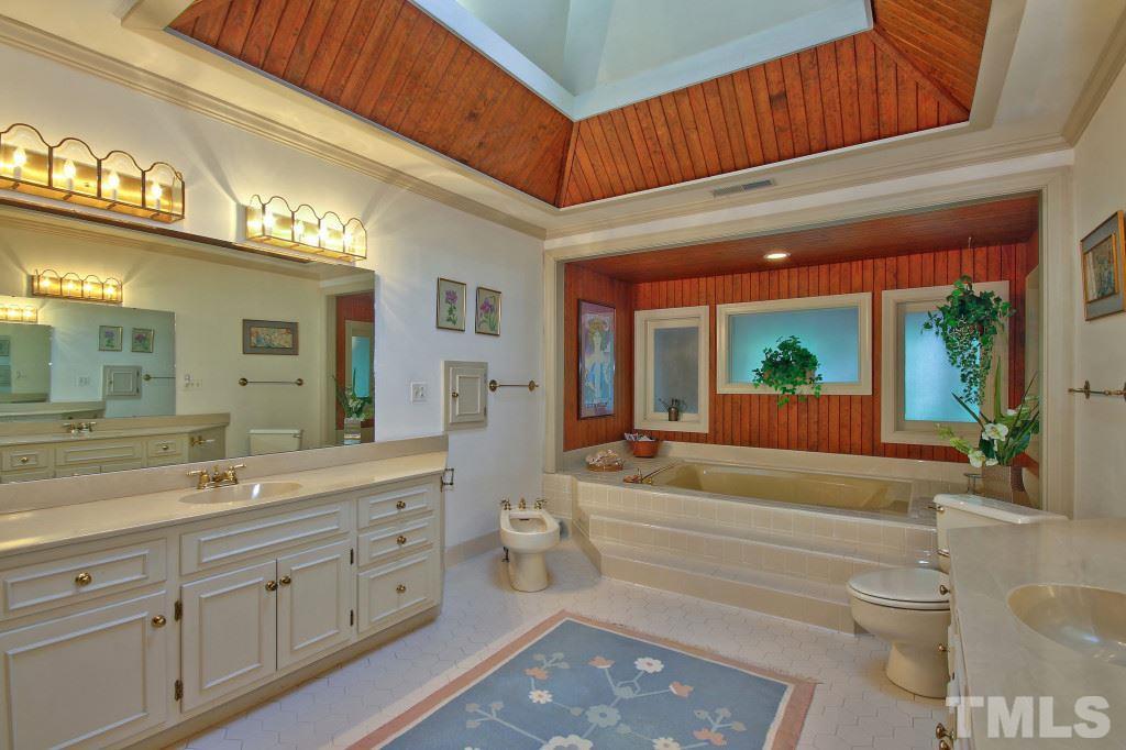 6257 Moore Road Red Oak, NC 27856 - Photo 15 of 25 a spacious bathroom with a double vanity sink a large mirror and a bathtub