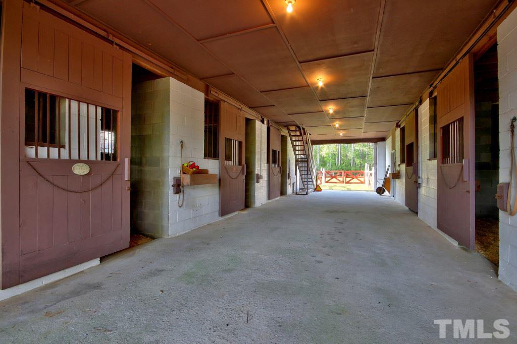 6257 Moore Road Red Oak, NC 27856 - Photo 21 of 25 a view of a hallway with floor to ceiling window and refrigerator