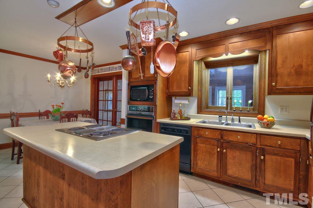 6257 Moore Road Red Oak, NC 27856 - Photo 5 of 25 a kitchen with a sink a stove and cabinets