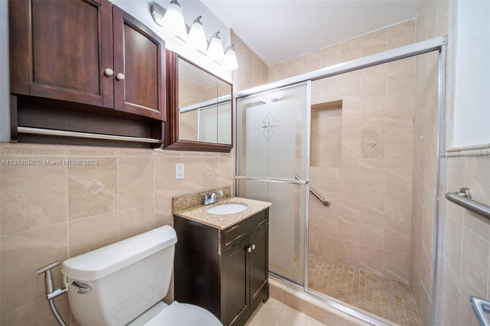 1911 Southwest 23rd Street Miami, FL 33145 - Photo 12 of 48 a bathroom with a sink a toilet and shower