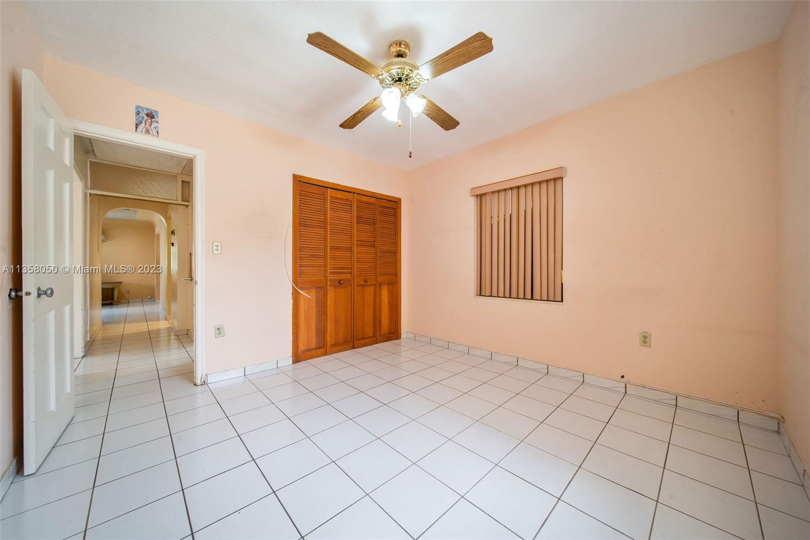 1911 Southwest 23rd Street Miami, FL 33145 - Photo 22 of 48 an empty room with fan and windows