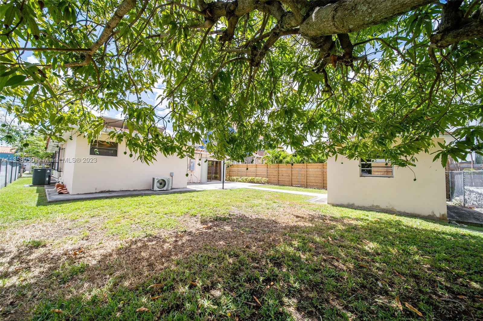 1911 Southwest 23rd Street Miami, FL 33145 - Photo 35 of 48 a backyard of a house with plants and large tree