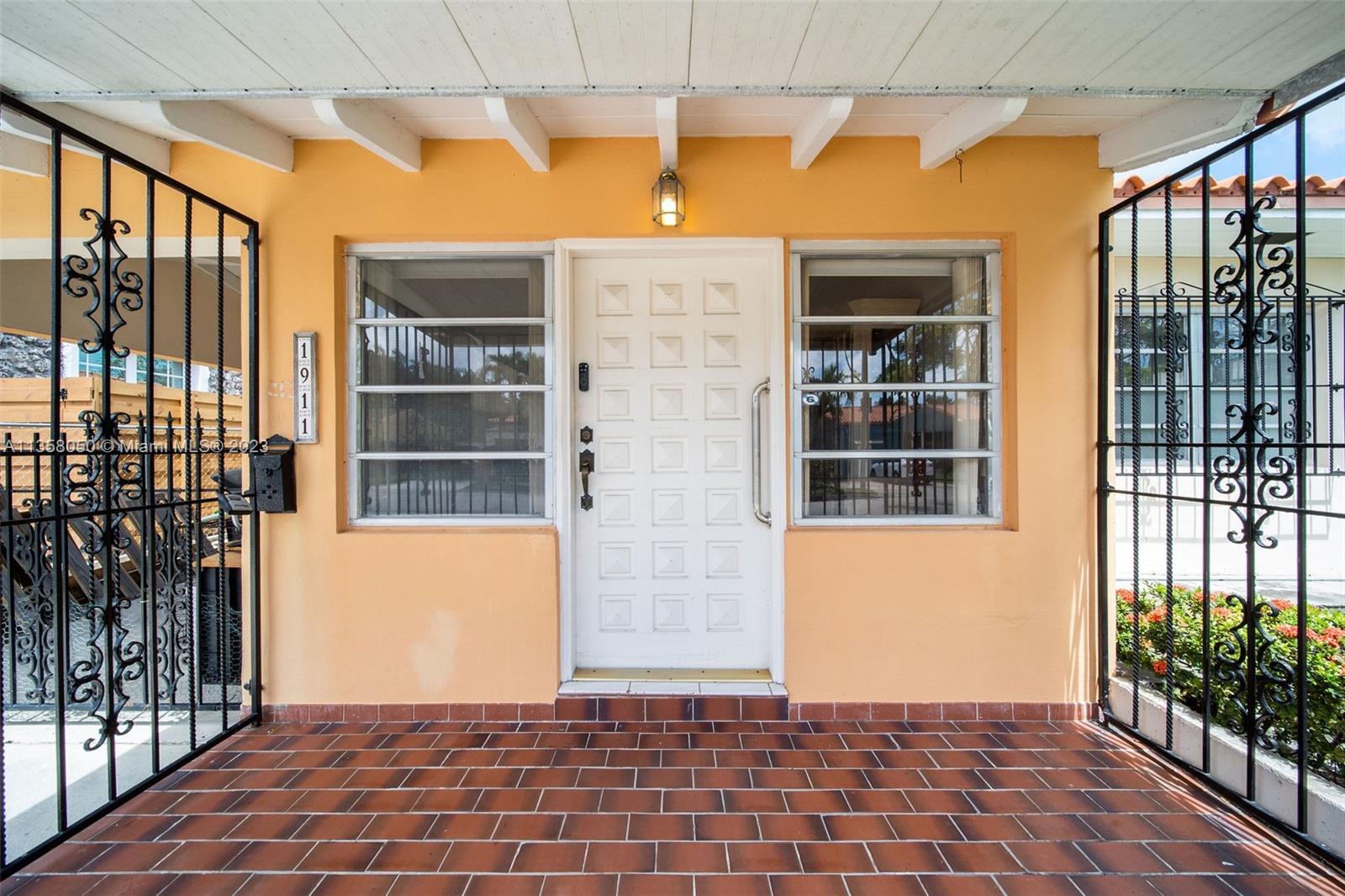 1911 Southwest 23rd Street Miami, FL 33145 - Photo 4 of 48 a front view of a house with a glass door