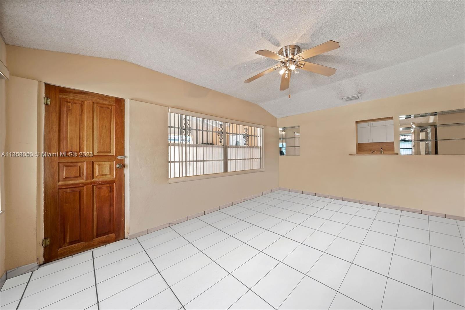 1911 Southwest 23rd Street Miami, FL 33145 - Photo 5 of 48 a view of an empty room with window and chandelier fan