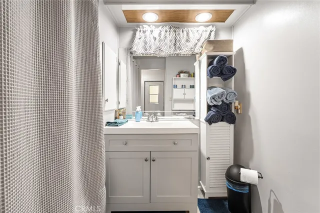a hallway with white cabinets and wooden floor