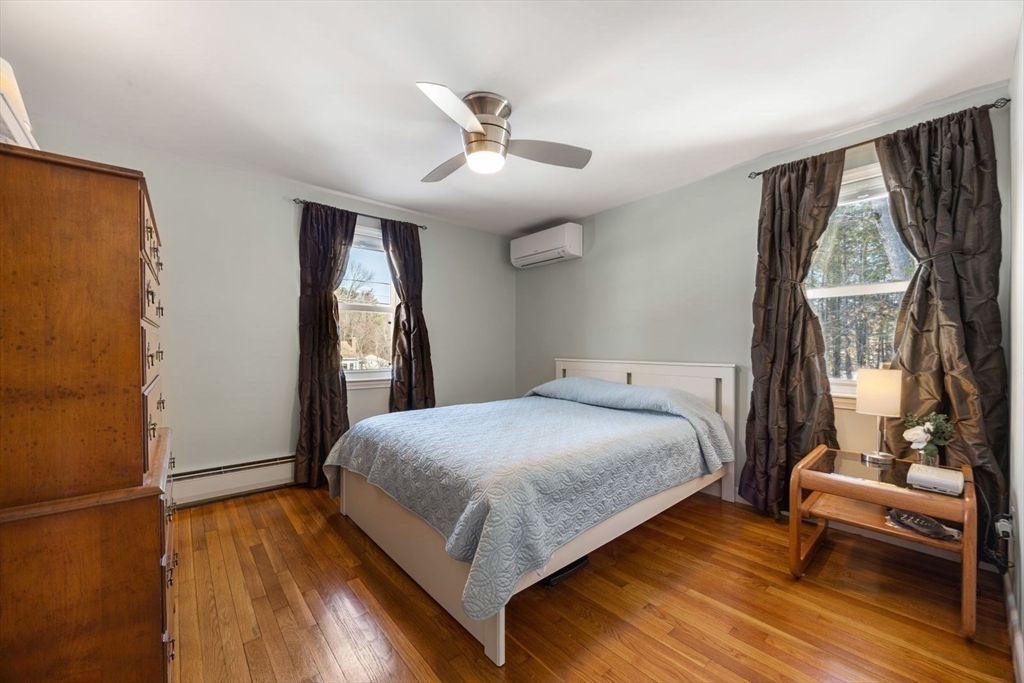 6 Cross Street Foxboro, MA 02035 - Photo 13 of 26 a bedroom with a bed and wooden floor