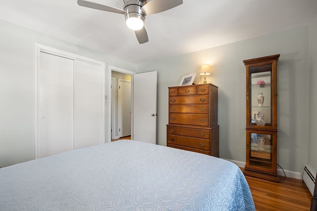 6 Cross Street Foxboro, MA 02035 - Photo 14 of 26 a bedroom with a bed and wooden floor