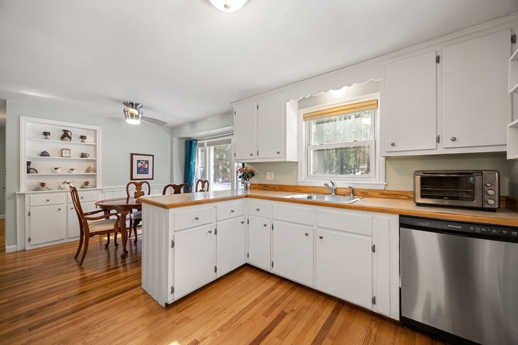 6 Cross Street Foxboro, MA 02035 - Photo 3 of 26 a open kitchen with granite countertop a sink cabinets and wooden floor