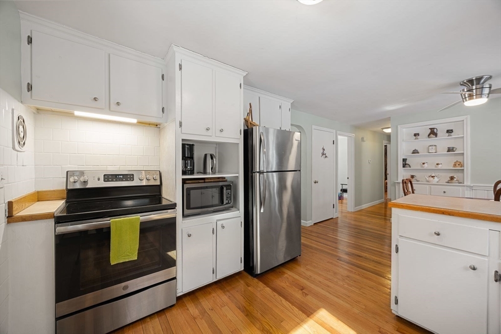 6 Cross Street Foxboro, MA 02035 - Photo 5 of 26 a kitchen with granite countertop white cabinets and stainless steel appliances