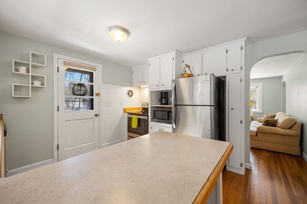 6 Cross Street Foxboro, MA 02035 - Photo 6 of 26 a kitchen with stainless steel appliances a refrigerator and a couch