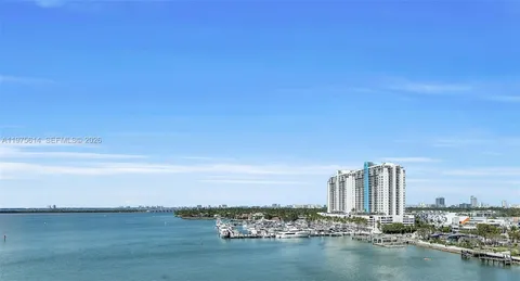 a view of a city with tall buildings in ocean