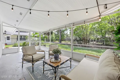 a view of a room with wooden floor and outdoor seating