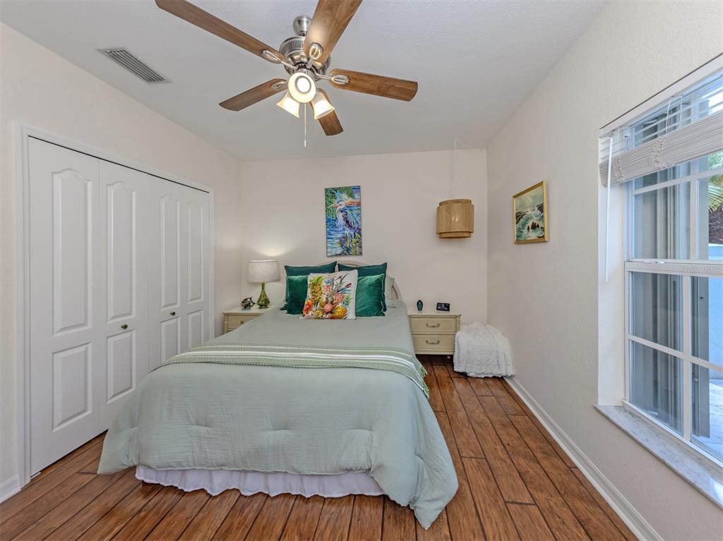 205 Reclinata Circle Venice, FL 34292 - Photo 29 of 62 a bedroom with a bed and wooden floor