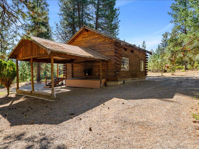 40060 Incline Drive Chiloquin, OR 97624 - Photo 5 of 26 a view of a patio with a table and chairs under an umbrella