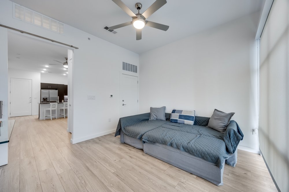 4801 Springdale Road, Unit 2107 Austin, TX 78723 - Photo 18 of 26 a living room with furniture and a wooden floor