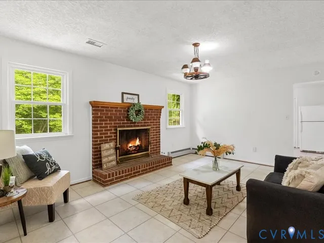 a living room with furniture and a fireplace