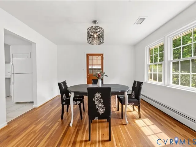 a view of a dining room with furniture window and wooden floor
