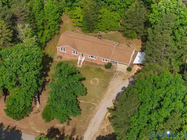 an aerial view of a house with a yard
