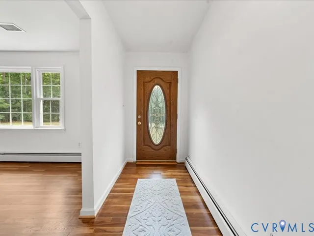a living room with furniture a fireplace and a large window