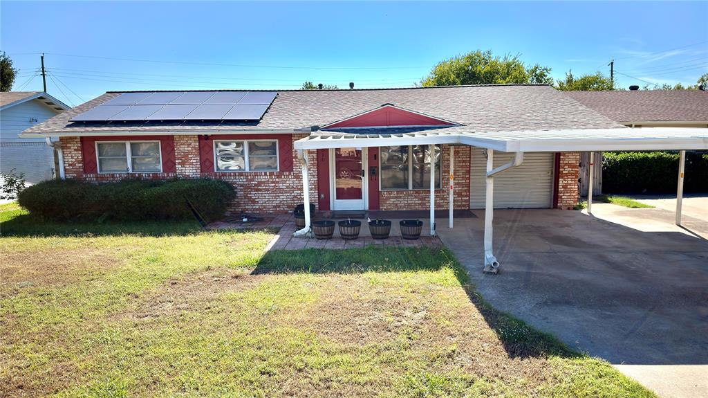 2510 Dewitt Street Irving, TX 75062 - Photo 2 of 17 Ranch-style home with a shingled roof, a carport, brick siding, and a front lawn