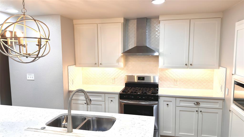 2510 Dewitt Street Irving, TX 75062 - Photo 3 of 17 a kitchen with stainless steel appliances granite countertop a sink and a stove