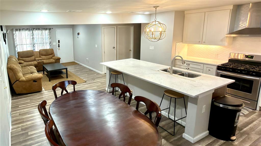 2510 Dewitt Street Irving, TX 75062 - Photo 4 of 17 a living room with stainless steel appliances furniture a rug and a kitchen